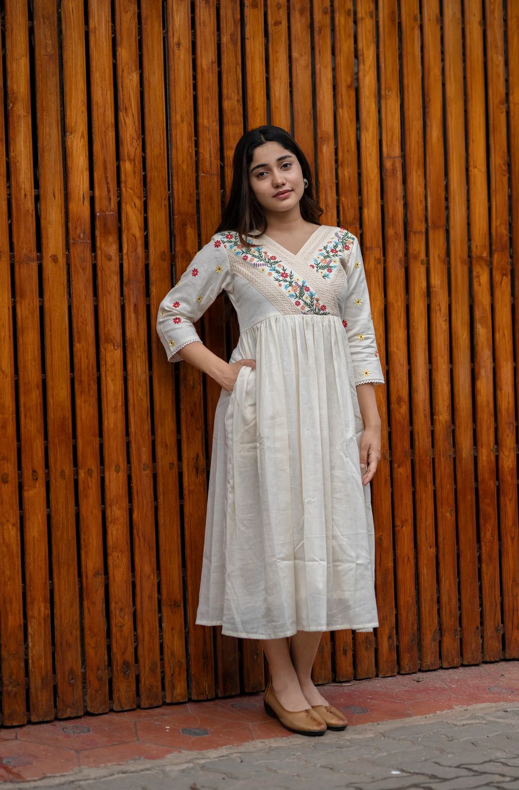 off-white cotton Kurti designed with floral embroidery and crochet lace detailing