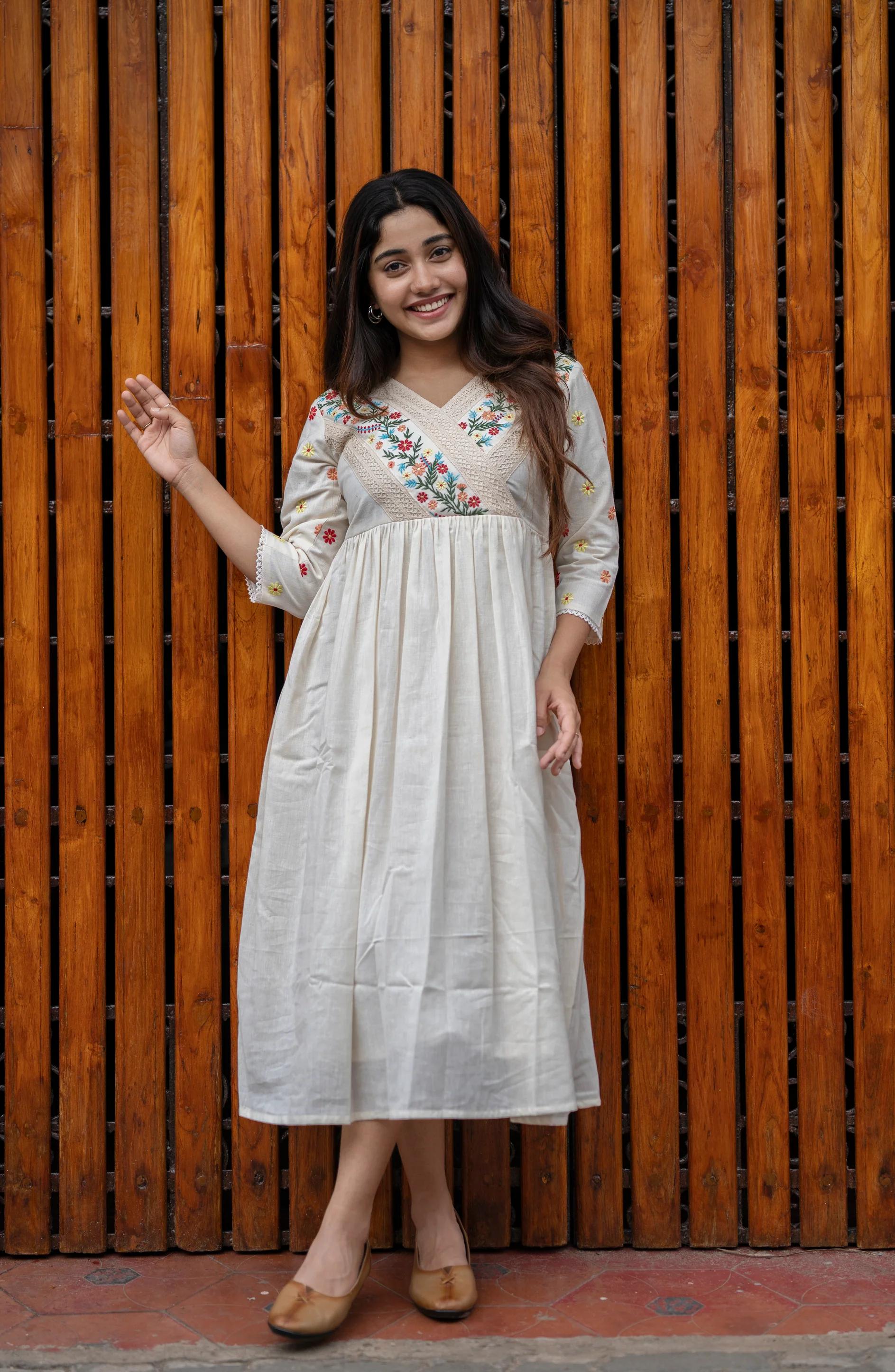 off-white cotton Kurti designed with floral embroidery and crochet lace detailing