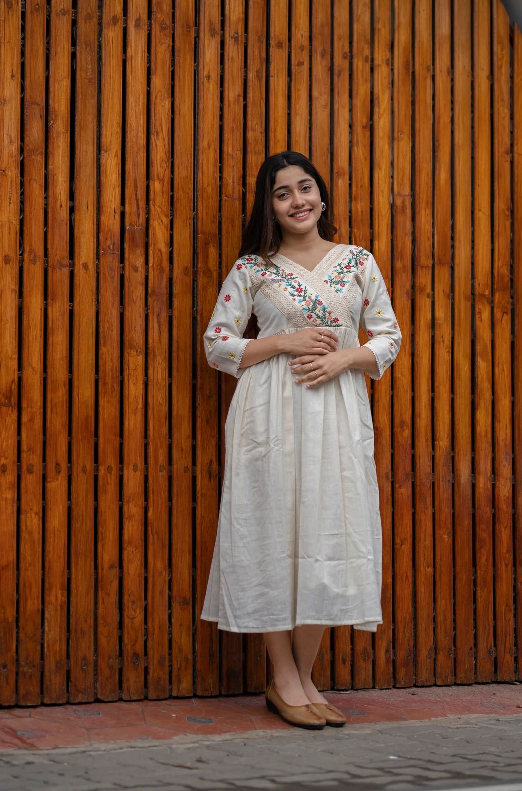 off-white cotton Kurti designed with floral embroidery and crochet lace detailing