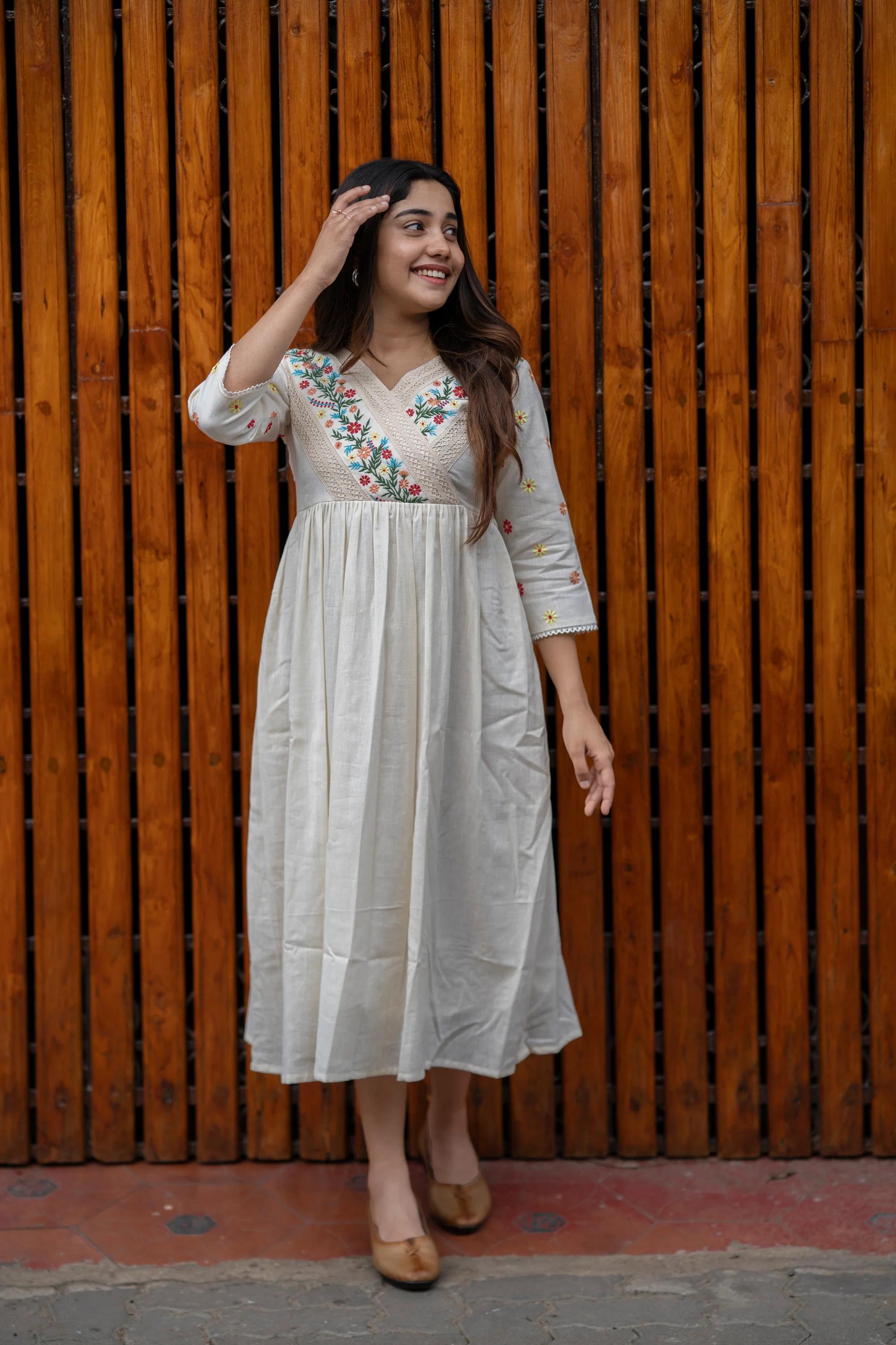 off-white cotton Kurti designed with floral embroidery and crochet lace detailing